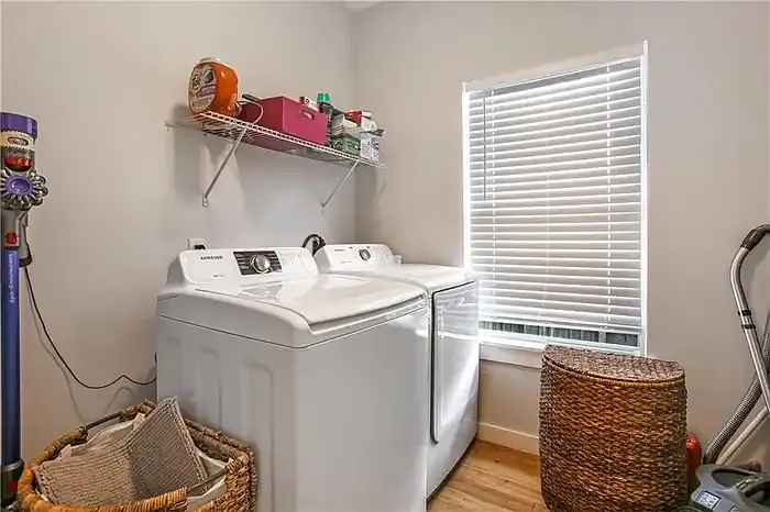 In-unit laundry room with full size washer and dryer
