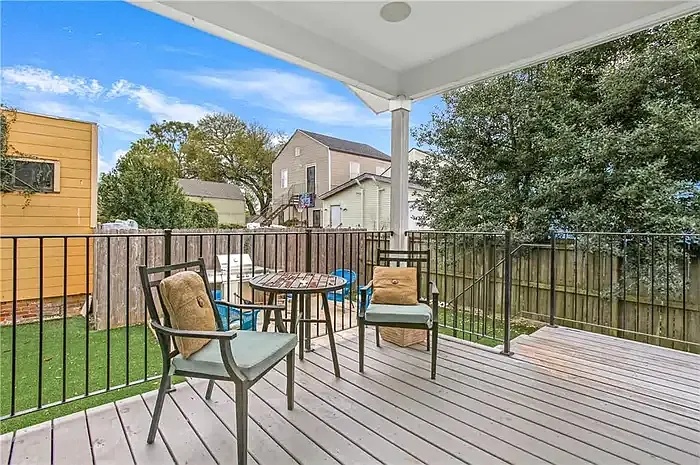 Covered rear deck overlooking the fenced yard