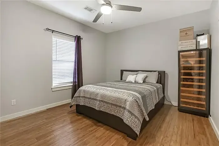 Bedroom with ceiling fan and hardwood floors
