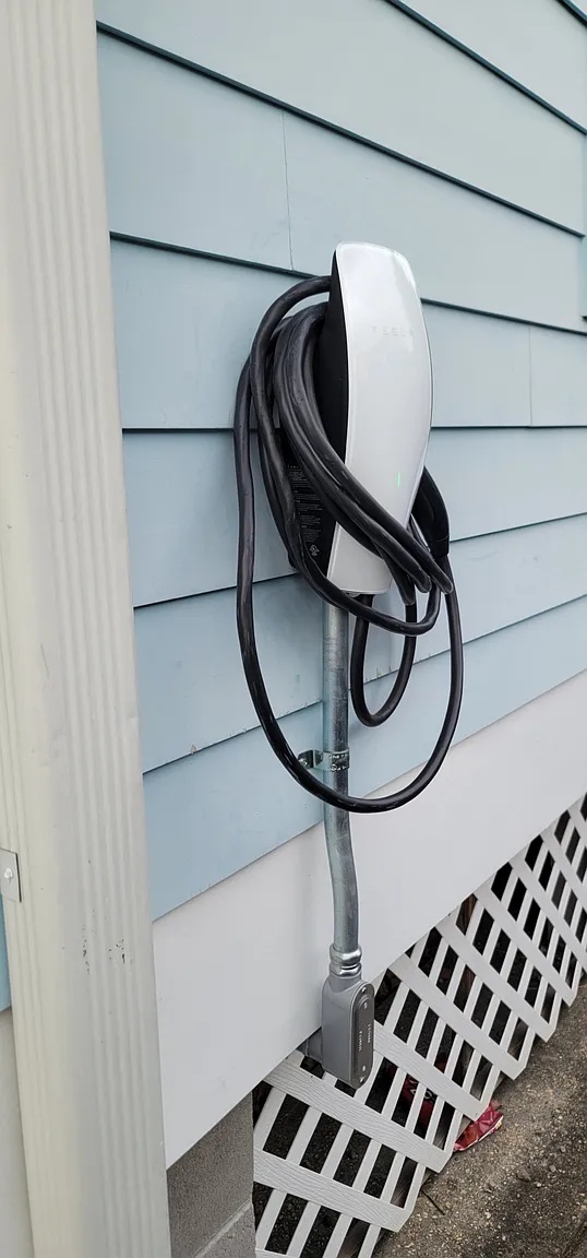 Tesla wall connector EV charger mounted outside the home