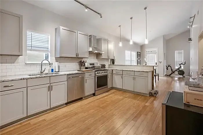 Renovated kitchen with gas range and vaulted ceilings