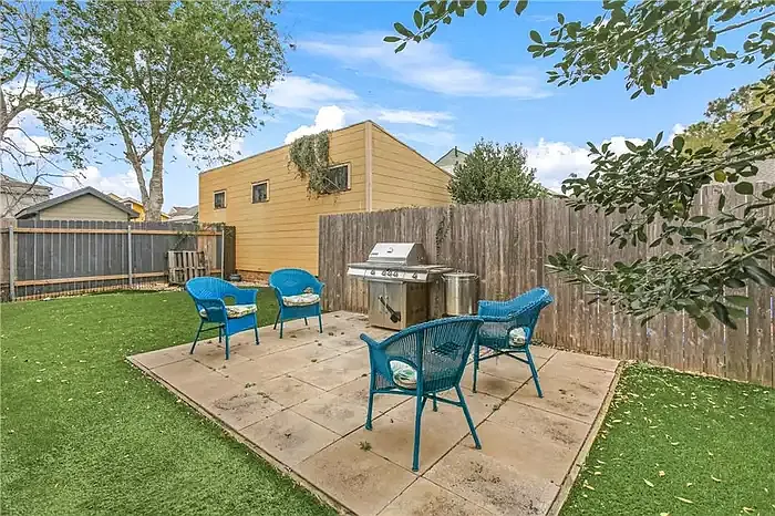 Fenced backyard with paver patio and grill
